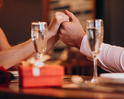 Couple holding hands on valentines evening in a restaurant